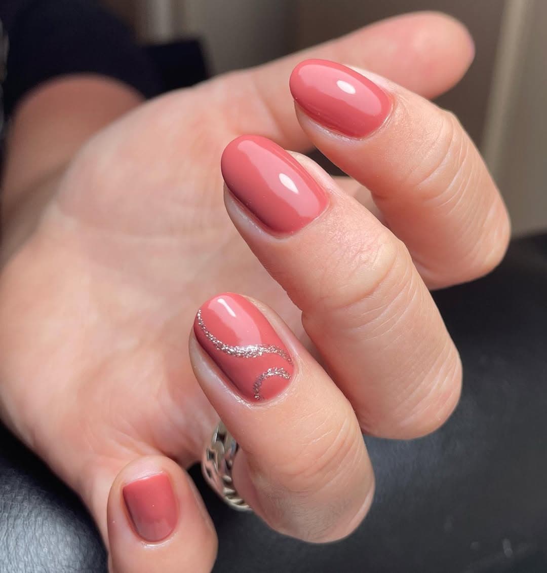 Koraalroze nagels met zilveren swirl accent