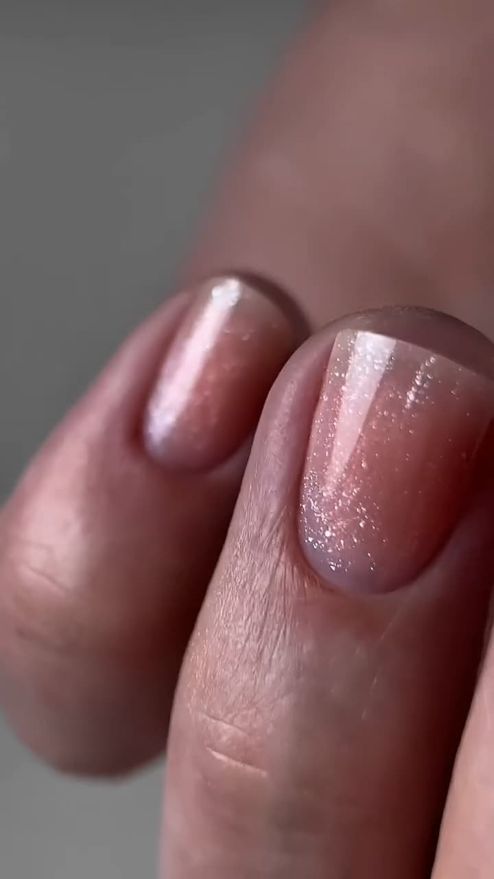 Close-up van zachtroze nagels met een subtiele glans